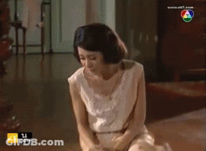 Woman In White Kneeling At TV Saying Ek7.com GIF