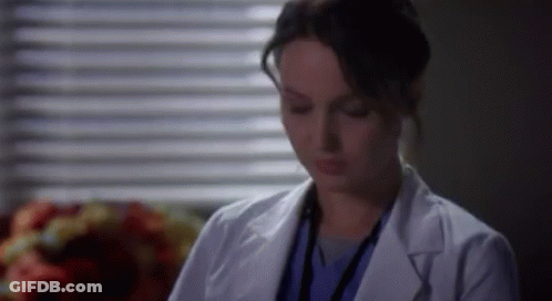 Woman In White Lab Coat Sitting By Window GIF