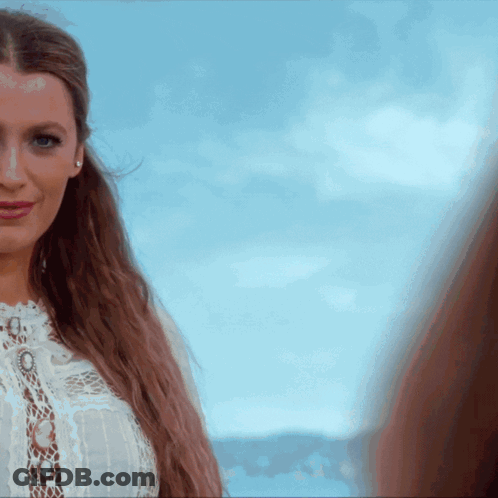 Woman In White Lace Top Looking At Camera GIF
