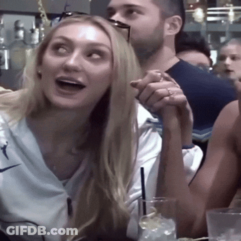 Woman In White Nike Shirt Holding Man's Arm GIF