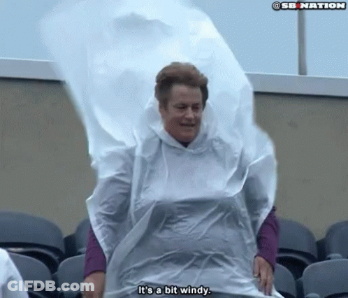 Woman In White Poncho Says It Is A Bit Windy GIF