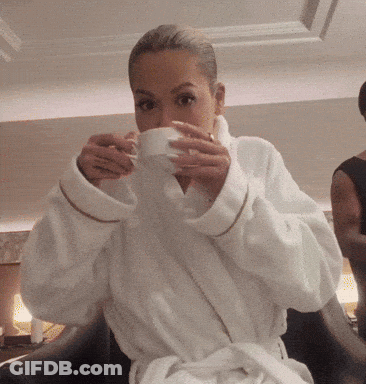 Woman In White Robe Drinking From Cup GIF