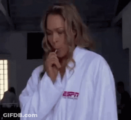 Woman In White Robe Holding Lollipop GIF