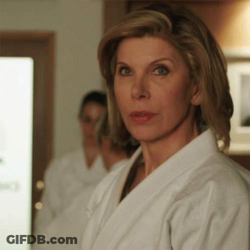 Woman In White Robe Looking At Camera GIF