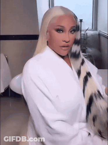 Woman In White Robe Sitting In Bathroom GIF