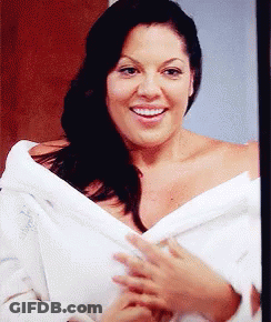 Woman In White Robe Smiling At Camera GIF