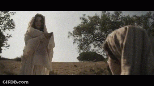 Woman In White Robe Standing In Field GIF