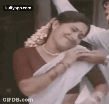 Woman In White Saree Next To Man In Red Shirt GIF