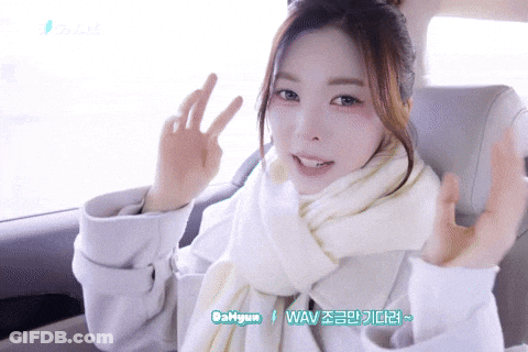 Woman In White Scarf Coat Giving Peace Sign GIF