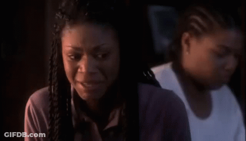 Woman In White Shirt And Black Vest In Dark Room GIF