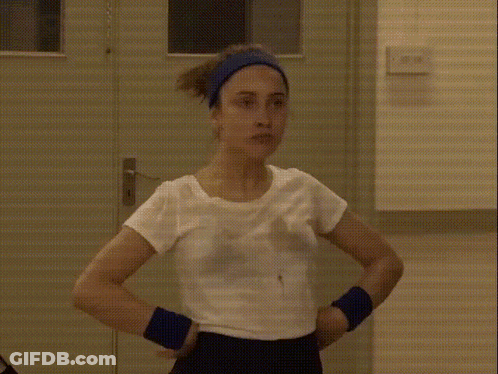 Woman In White Shirt And Blue Headband At Door GIF