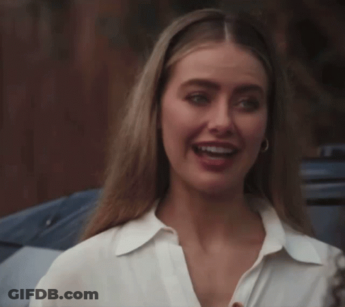 Woman In White Shirt And Hoop Earrings Smiling GIF