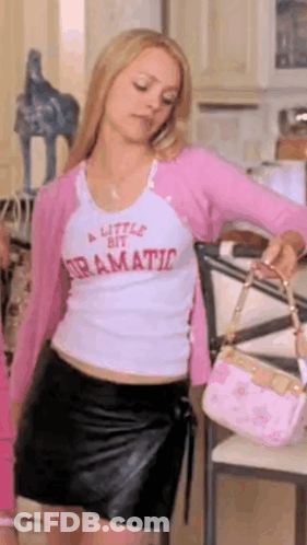 Woman In White Shirt And Pink Cardigan Holding Pink Bag GIF
