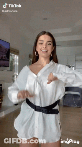 Woman In White Shirt And Shorts Dancing In Living Room GIF