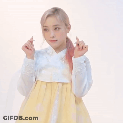 Woman In White Shirt And Yellow Skirt Making Funny Face GIF