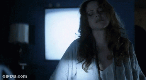 Woman In White Shirt By Blue Wall GIF