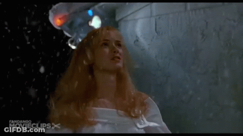 Woman In White Shirt Covering Face In Rain GIF