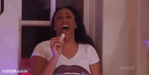 Woman In White Shirt Eating Candy Bar GIF