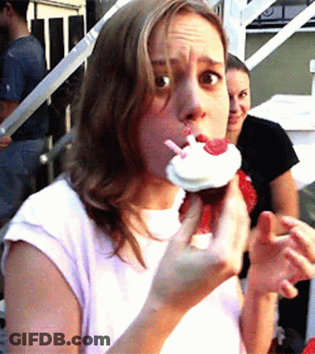Woman In White Shirt Eating Cupcake GIF