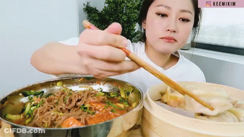 Woman In White Shirt Eating Noodles With Chopsticks Keemikim GIF