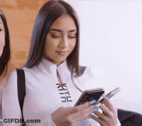 Woman In White Shirt Holding Cell Phone GIF