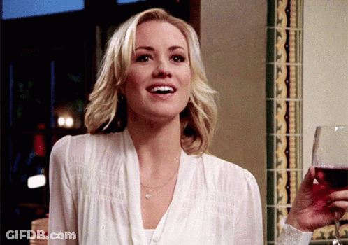 Woman In White Shirt Holding Glass Of Red Wine GIF