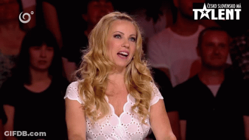 Woman In White Shirt In Front Of Crowd And Talent Sign GIF