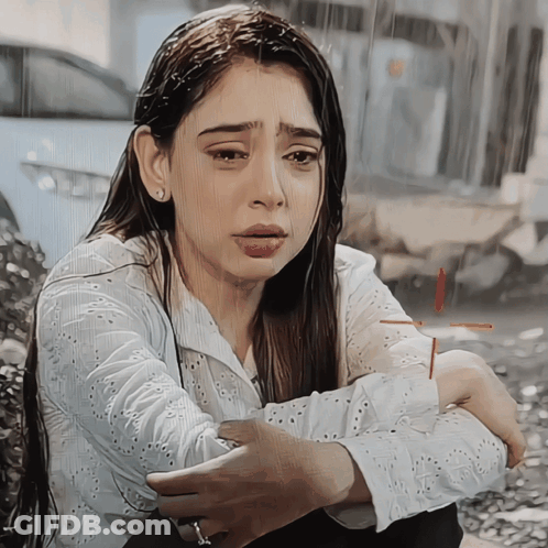 Woman In White Shirt Kneeling In Rain GIF