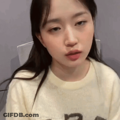 Woman In White Shirt Looking At Camera GIF