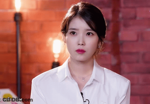 Woman In White Shirt Looking At Camera With Safe Zone GIF
