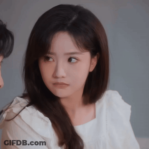 Woman In White Shirt Looking At Man GIF