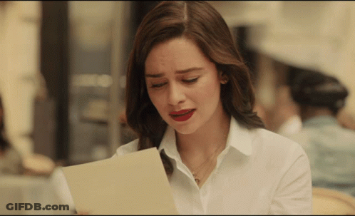 Woman In White Shirt Looking At Paper GIF