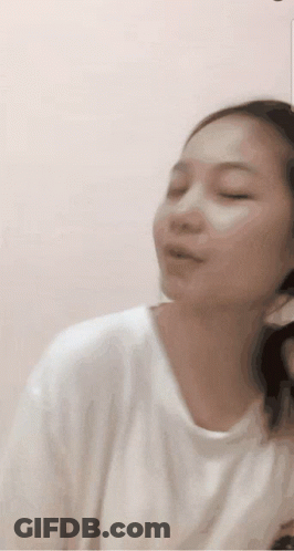 Woman In White Shirt Making Funny Face With Eyes Closed GIF