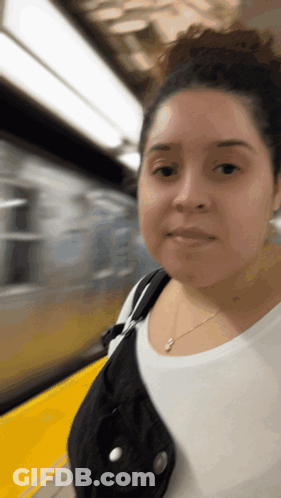 Woman In White Shirt On Train Platform GIF