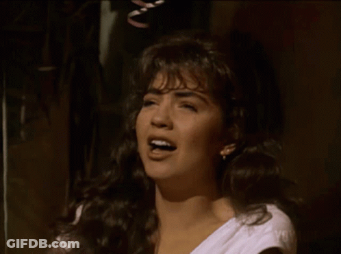 Woman In White Shirt Singing Into Microphone GIF