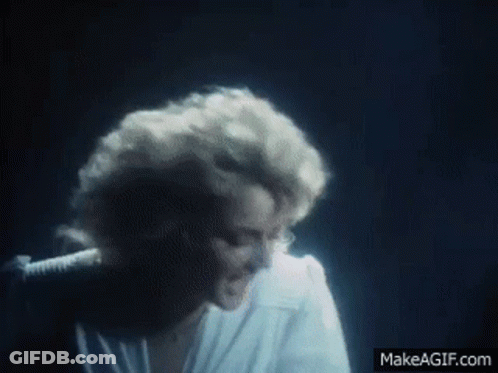Woman In White Shirt Singing Into Microphone GIF