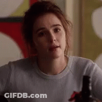 Woman In White Shirt Sitting At Table With Wine Bottle GIF