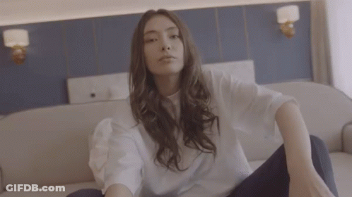Woman In White Shirt Sitting Crossed Legs GIF