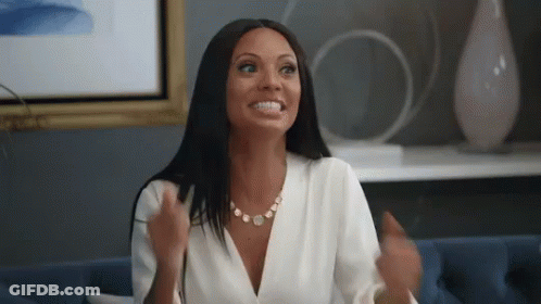 Woman In White Shirt Sitting On Blue Couch GIF