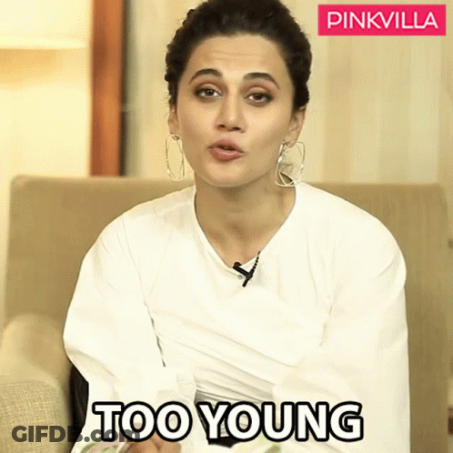 Woman In White Shirt Sitting On Couch Saying Too Young GIF