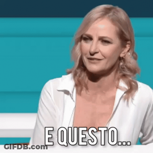 Woman In White Shirt Sitting Saying E Questo GIF