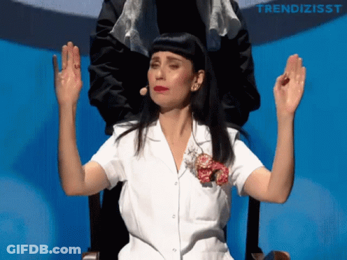 Woman In White Shirt Sitting With Arms Out GIF