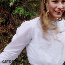 Woman In White Shirt Smiling In Grass GIF