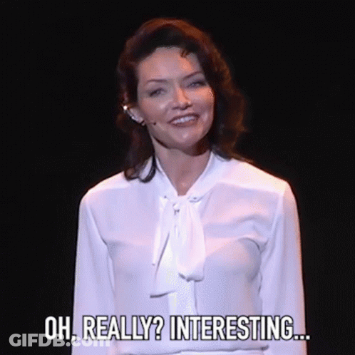 Woman In White Shirt Smiling On Stage GIF