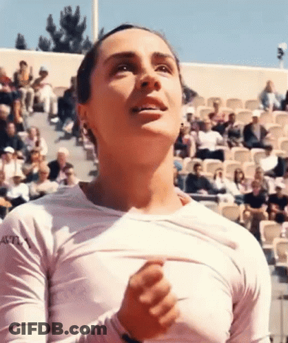 Woman In White Shirt Taking Off Shirt In Front Of Crowd GIF
