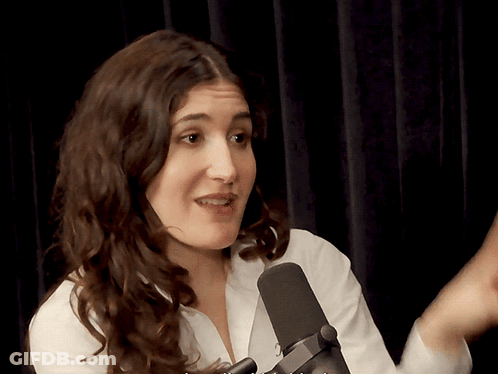Woman In White Shirt Talking Into Black Microphone GIF