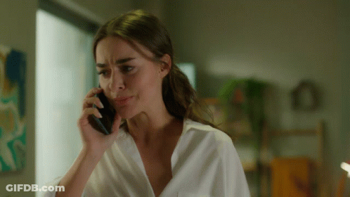 Woman In White Shirt Talking On Phone GIF