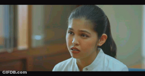 Woman In White Shirt Talking To Someone In Room GIF