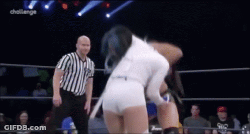 Woman In White Shorts Wrestling Man In Striped Shirt In Ring GIF