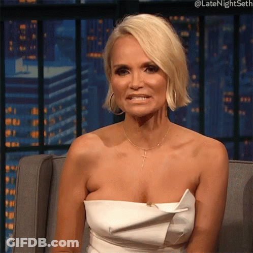 Woman In White Strapless Dress Sitting And Smiling GIF